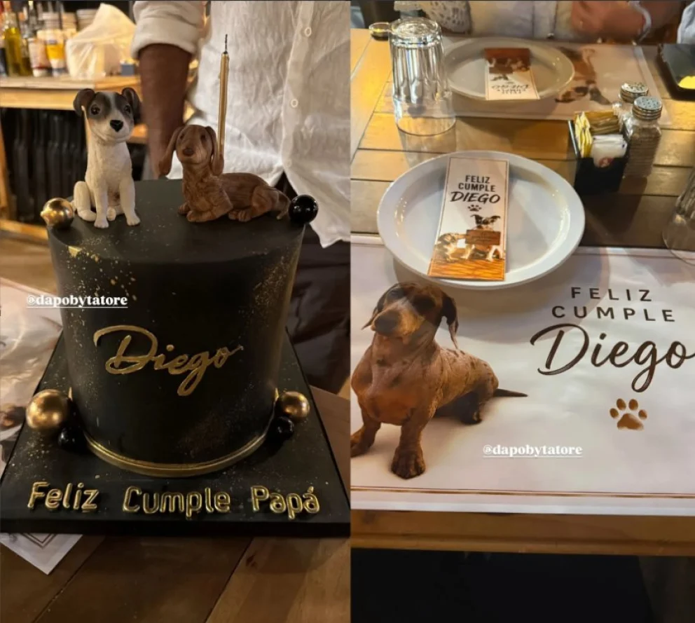 Torta de cumplea&ntilde;os negra con detalles dorados y individuales con un tarjeta de bienvenida, con perros como tematica principal